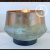 Handcrafted copper table lamp with a rustic patina, featuring a vintage-style bulb.