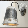Distressed farmhouse wall sconce; galvanized metal, whitewash finish, black arm.
