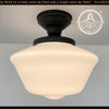 Elegant Schoolhouse 1930s antique milk glass ceiling light with black metal canopy.