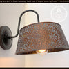 Ornate copper wall sconce with embossed floral pattern; The Lamp Goods.