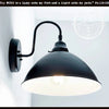 Black enamel farmhouse wall sconce with curved arm; adds rustic charm.