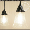 Clear seeded glass pendant light with black metal shade, perfect for farmhouse or vintage decor.