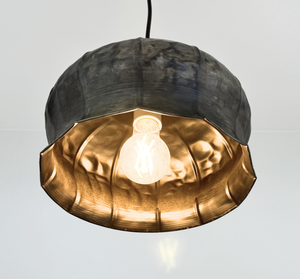 Forged metal pendant light with rustic farmhouse character