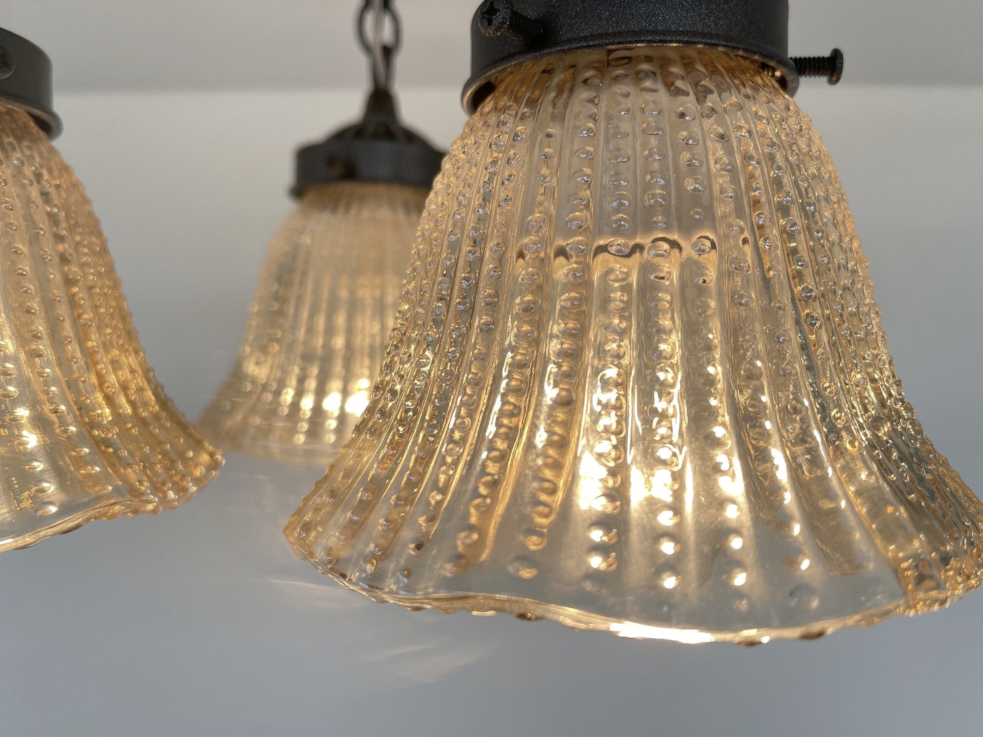 Amber glass hobnail ceiling light fixture, vintage 1930s design.

