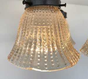 Amber glass ceiling light fixture, hobnail detailing, vintage 1930s style.
