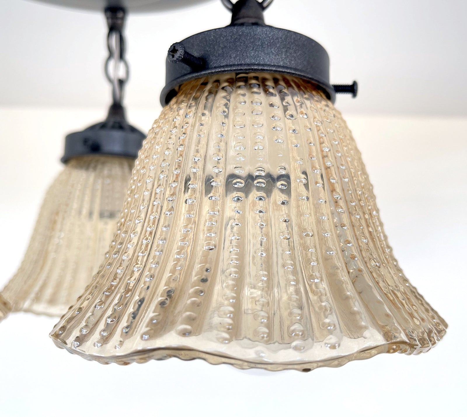 Amber glass ceiling light fixture, hobnail detailing, vintage 1930s style.
