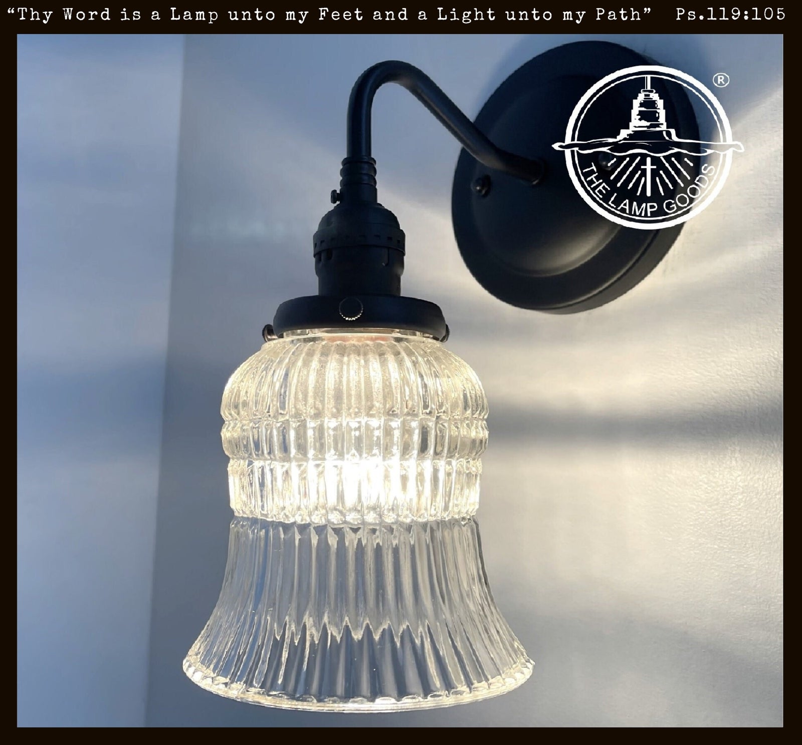 Antique 1950s Bell Holophane glass wall sconce; clear glass shade, black metal.
