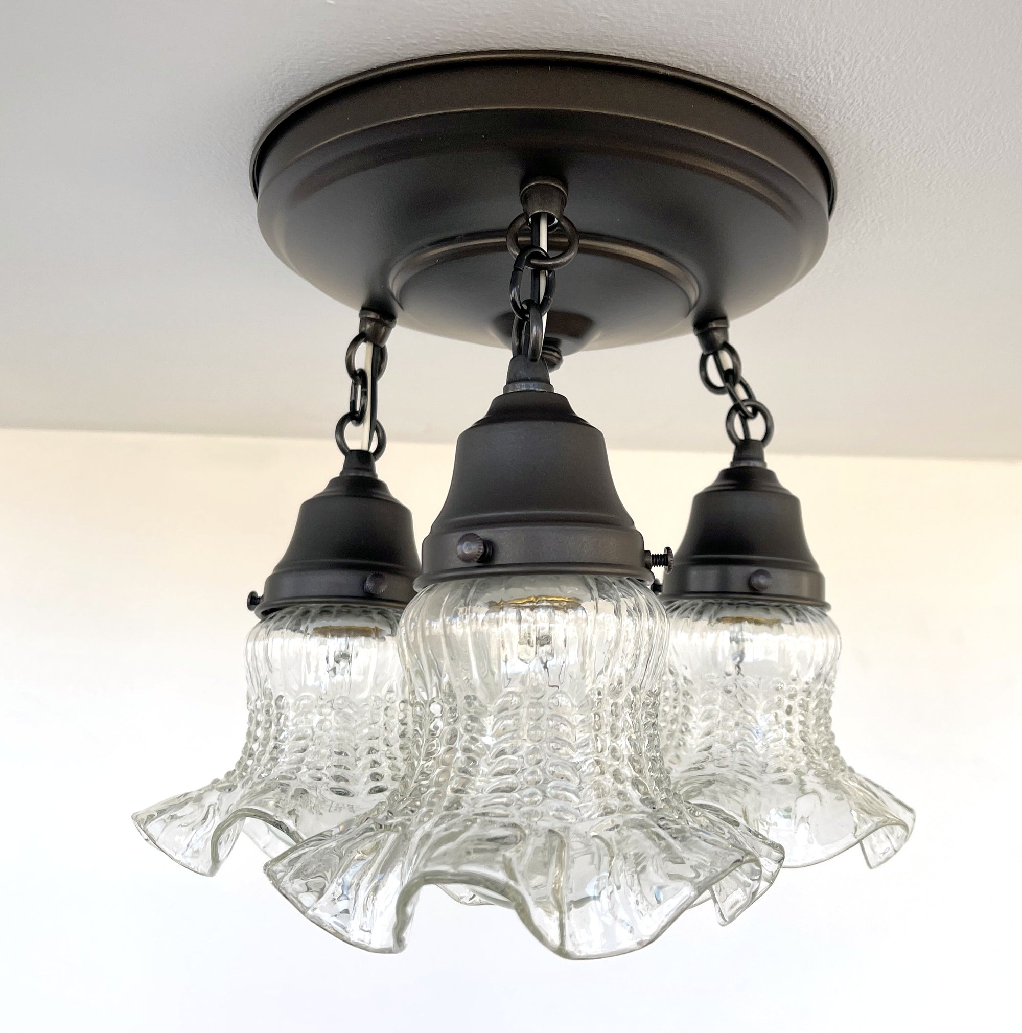 Three-light antique hobnail glass ceiling fixture with dark bronze finish.

