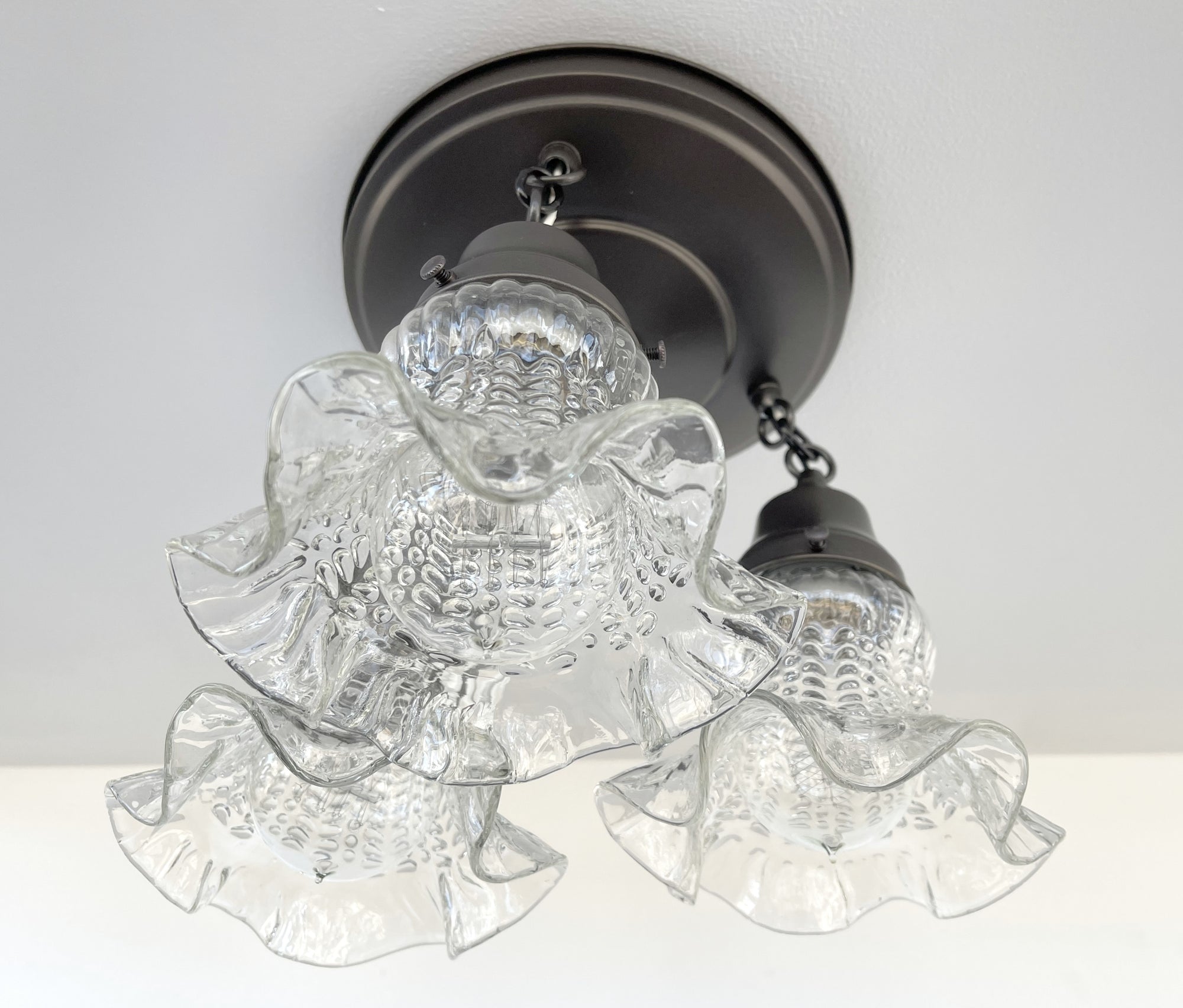Clear glass hobnail ceiling light fixture with ruffled edges, vintage 1930s style.
