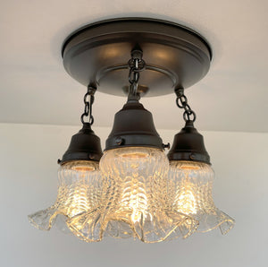Three-light antique hobnail glass ceiling fixture with dark bronze finish.
