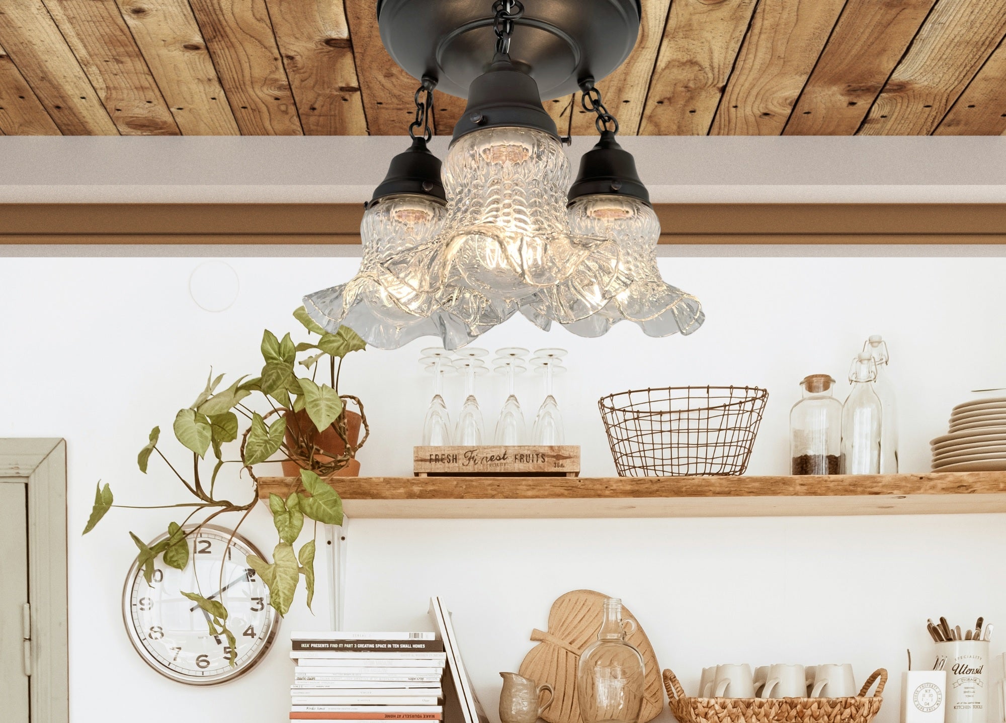 Antique glass hobnail ceiling light fixture, three-light design, installed on wood ceiling, above kitchen shelving.
