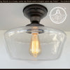 Large Schoolhouse Clear Glass Ceiling Light fixture with bronze finish from The Lamp Goods.
