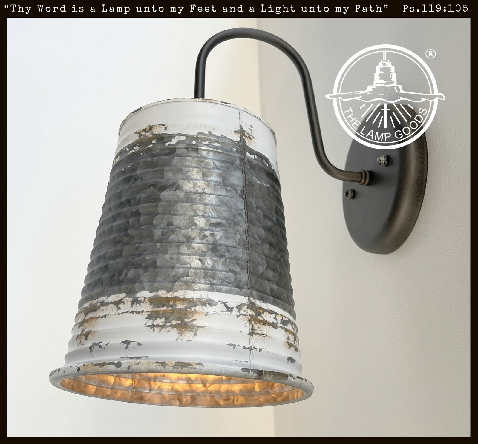 Distressed farmhouse wall sconce; galvanized metal, whitewash finish, black arm.
