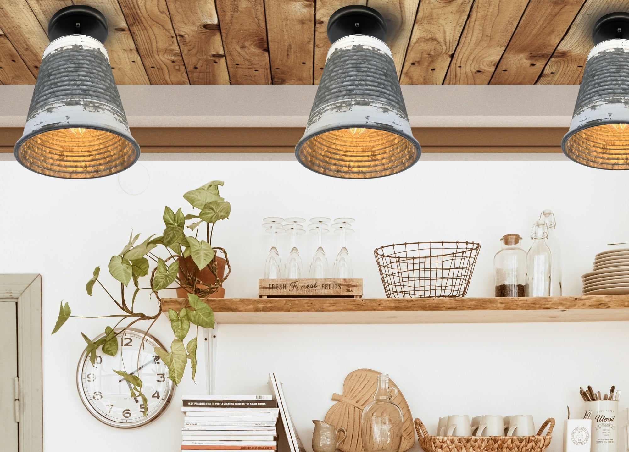 Rustic galvanized metal ceiling lights illuminating a farmhouse kitchen shelf.
