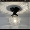 Antique glass globe ceiling light fixture with embossed roses; black metal mount.
