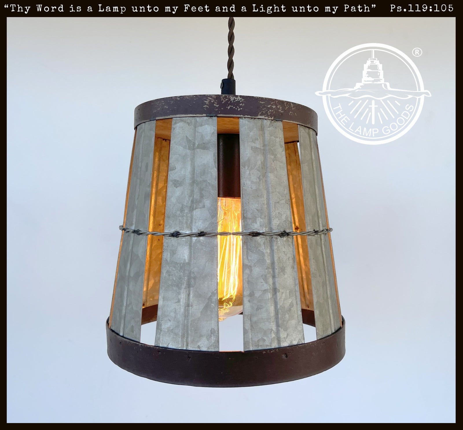 Galvanized metal industrial pendant light with open weave design and dark brown rim.
