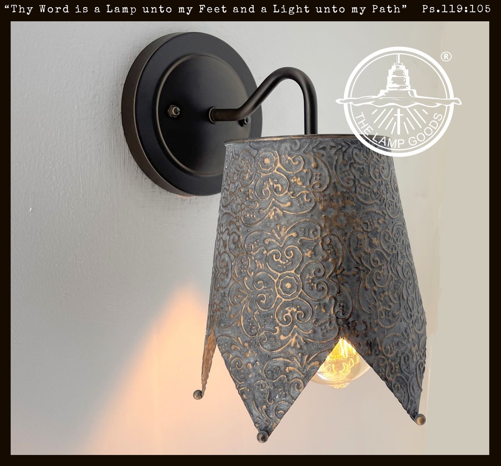 Ornate copper Jubilant wall sconce with embossed detail; dark bronze finish.
