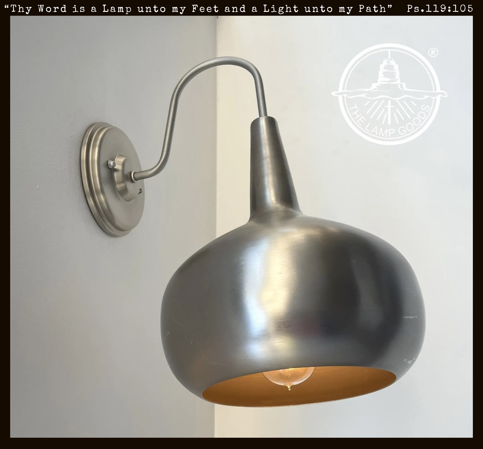 Polished steel modern wall sconce with large, curved shade; The Lamp Goods.
