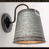 Rustic corrugated metal farmhouse wall light fixture with bronze arm.

