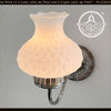 Antique quilted glass farmhouse wall light fixture with distressed metal accents.
