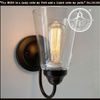 Modern farmhouse clear glass wall sconce with bronze finish.

