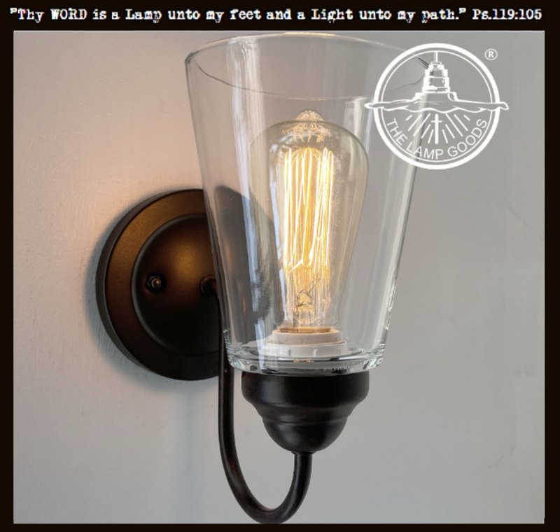 Modern farmhouse clear glass wall sconce with bronze finish.
