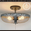 Industrial farmhouse flush mount ceiling light with galvanized metal shade and wire mesh.
