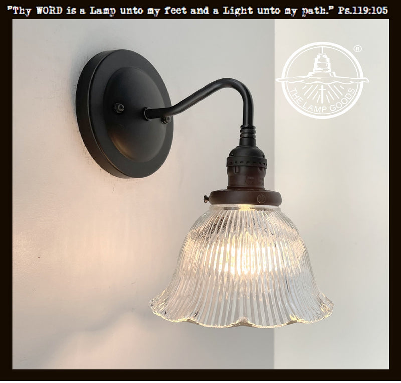 Antique Holophane glass wall sconce with ribbed dome shade & black metal arm.
