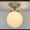 Brass Modern Milk Glass Ceiling Light, opal flush mount fixture with warm light.
