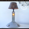 Antique chicken feeder lamp, repurposed as unique farmhouse table lamp with galvanized metal base.
