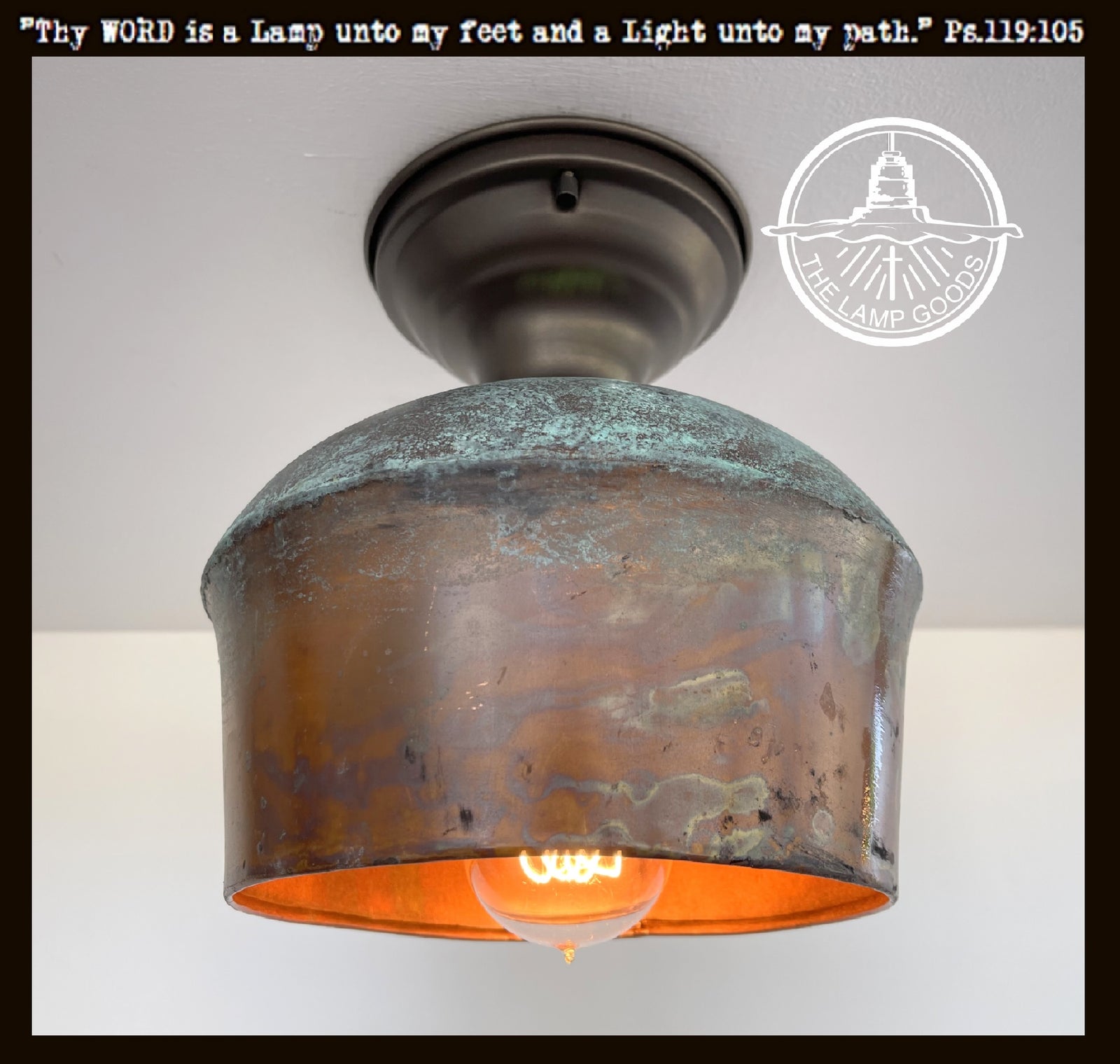 Rustic copper wall sconce with dark bronze mounting plate, illuminated by a warm-toned bulb.

