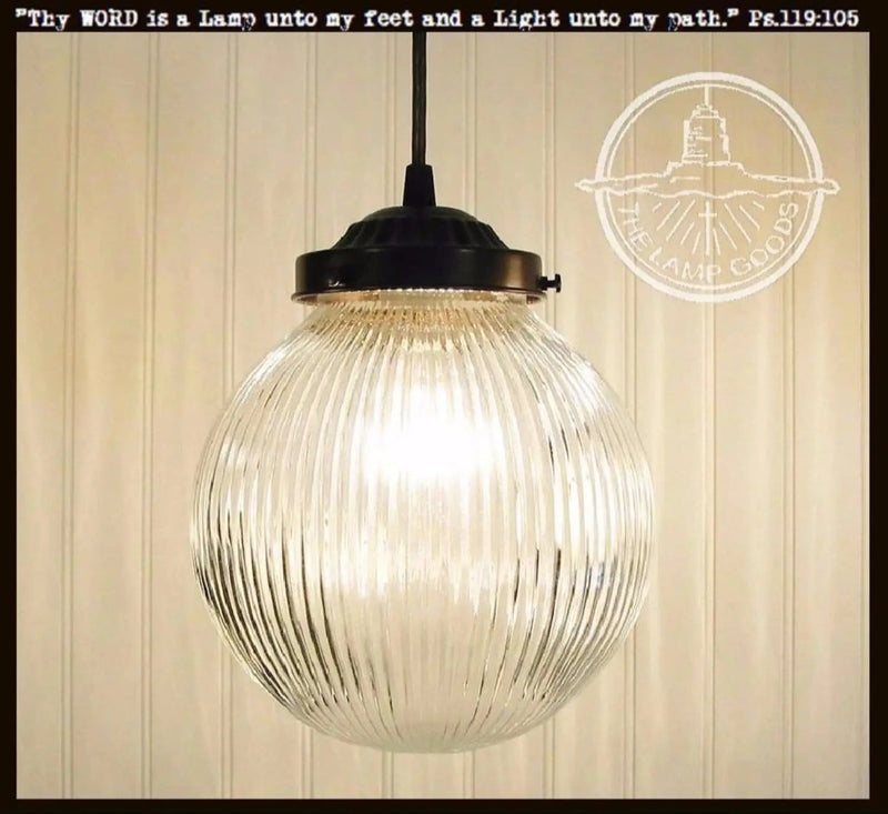 Antique large glass Holophane pendant light with ribbed glass shade and black metal fixture.
