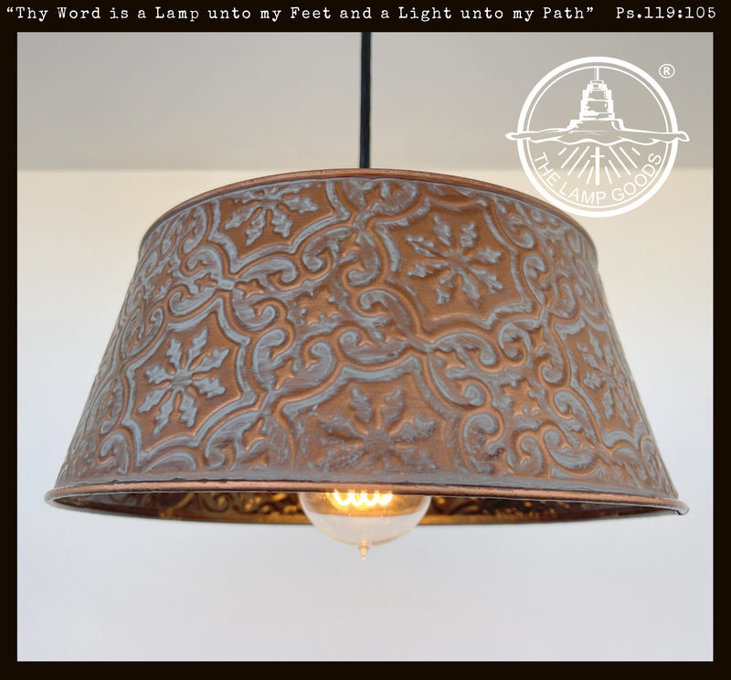 Ornate copper pendant light fixture with embossed floral pattern.
