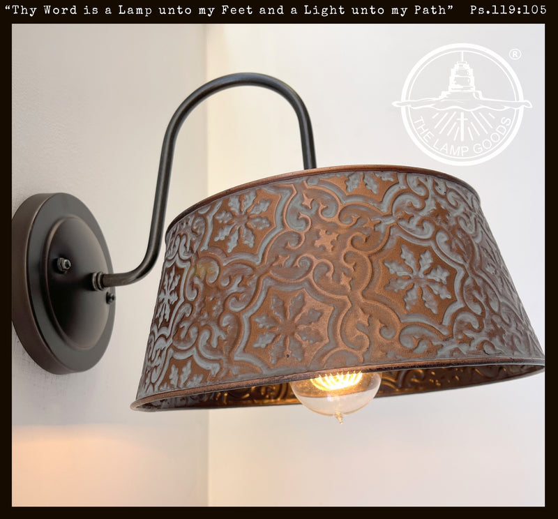 Ornate copper wall sconce with embossed floral pattern; The Lamp Goods.

