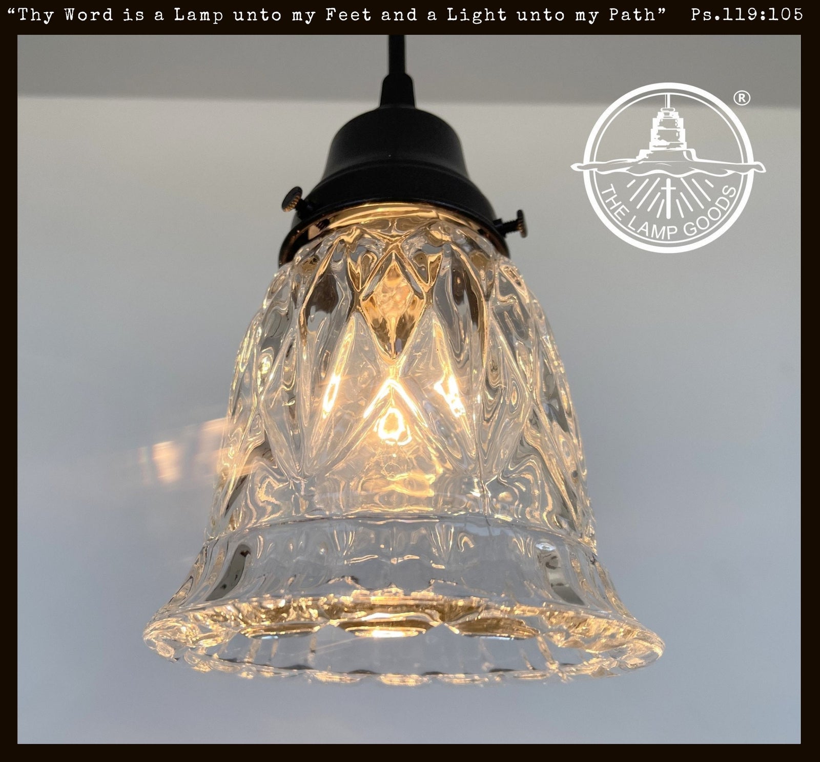 Vintage 1950s clear glass diamond pendant light fixture with black metal socket.
