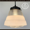 Retro 1970s mid-century glass pendant light; ribbed glass shade, opal glass diffuser, black metal canopy.
