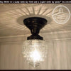 Acorn Glass Flush Mount Ceiling Light: Clear glass shade with black metal fixture.
