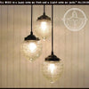 Acorn Glass Pendant Light Chandelier Trio: 3 clear glass shades with textured pattern, bronze hardware.
