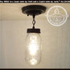 Mason jar ceiling light fixture with chain, quart-sized jar, and dark bronze finish.
