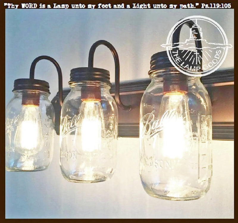 Triple Mason jar bathroom vanity light fixture with dark bronze accents.
