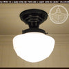 Milk glass mushroom ceiling light fixture with black metal canopy
