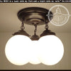 Milk glass opal globe ceiling light chain trio, black metal, 3-light fixture.
