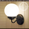 Milk glass modern wall sconce light fixture with black metal base.
