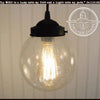 Antique seeded glass pendant light with black metal fixture.
