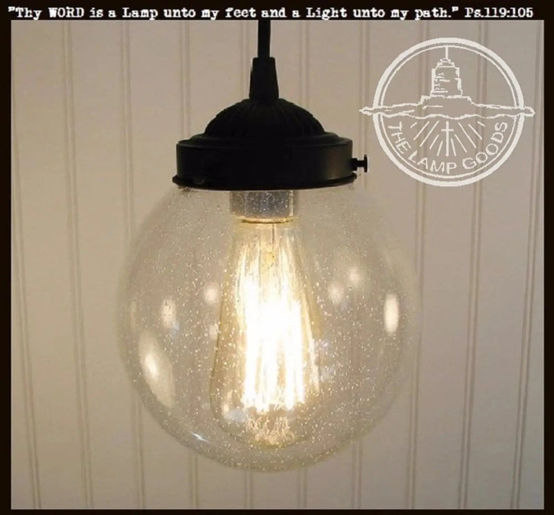 Antique seeded glass pendant light with black metal fixture.
