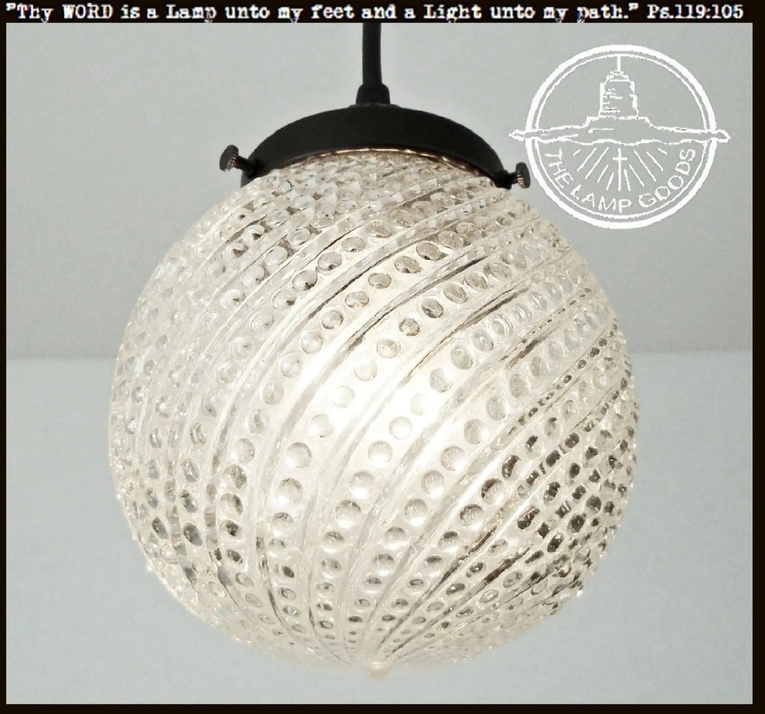 Clear glass Hobnail Swirl pendant light fixture with black metal fitting.
