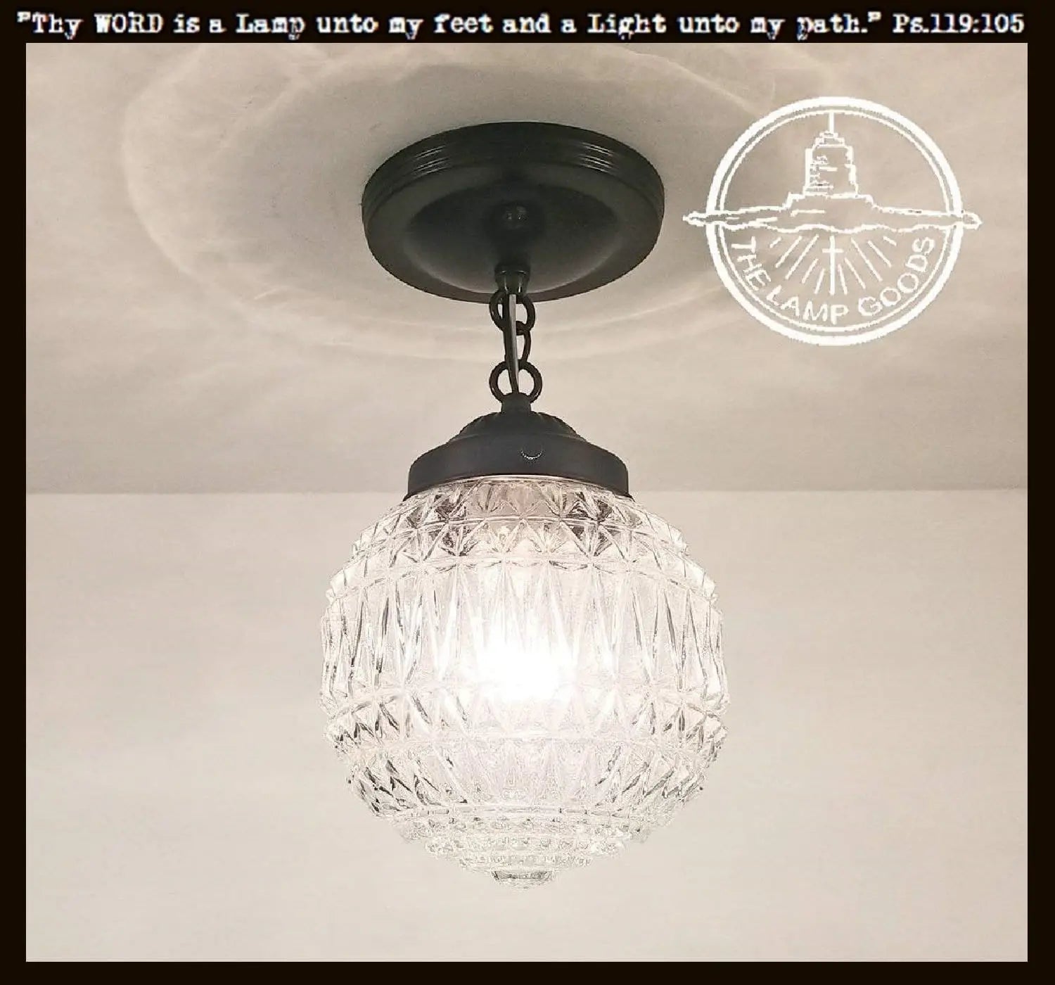 Vintage glass globe pendant light with black metal fixture.
