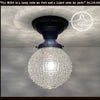 Antique diamond glass ceiling light fixture with black metal canopy.
