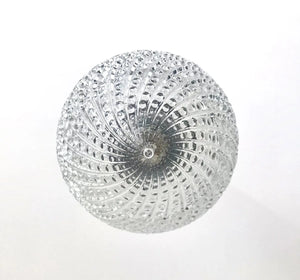 Clear glass pendant light fixture with hobnail swirl pattern.
