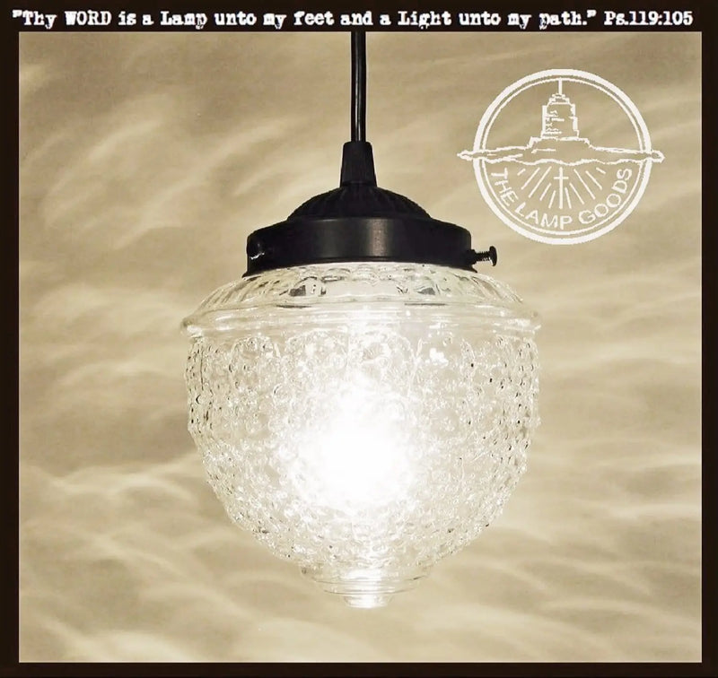 Antique clear glass pendant light with textured glass shade and black metal fixture.
